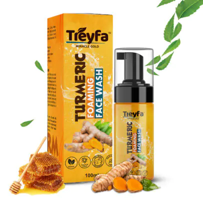 Bottle of Treyfa Foaming Turmeric Face Wash (100ml) with fresh turmeric root next to it.